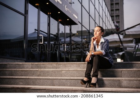Successful businesswoman or entrepreneur taking notes outdoor. City business woman working.