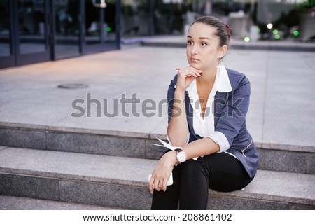 Successful businesswoman or entrepreneur taking notes outdoor. City business woman working.