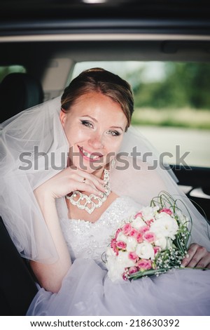 Portrait of a pretty bride in a car. close-up portrait of a pretty shy bride in a car window