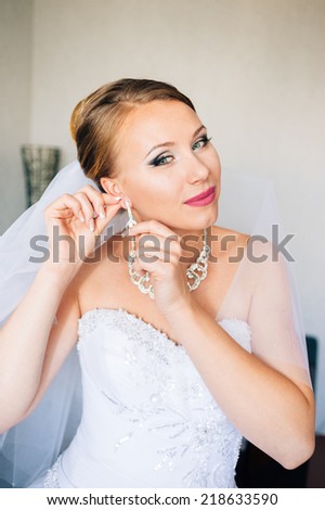 Beautiful bride is getting ready in the morning. adorable bride is getting ready in the morning. Portrait of beautiful woman in white dress