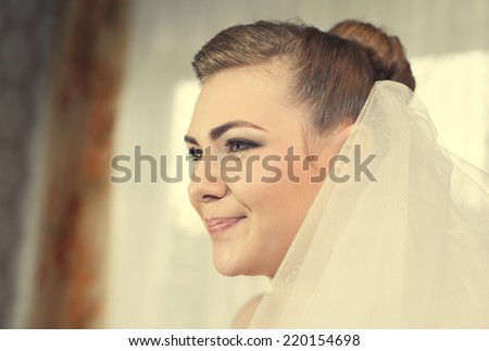 Bride getting ready. beautiful bride in white wedding dress with hairstyle and bright makeup. Happy sexy girl waiting for groom. lady in bridal dress have final preparation for wedding.