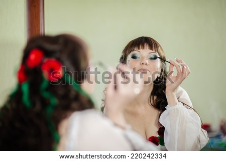 Portrait of ukrainian bride getting ready in the morning. Beautiful caucasian bride in national ukrainian clothes getting ready for the wedding ceremony.