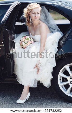 Portrait of a pretty bride in a car.  close-up portrait of a pretty shy bride in a car window.