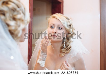 Bride getting ready. beautiful bride in white wedding dress with hairstyle and bright makeup. Happy sexy girl waiting for groom. Romantic lady in bridal dress have final preparation for wedding.