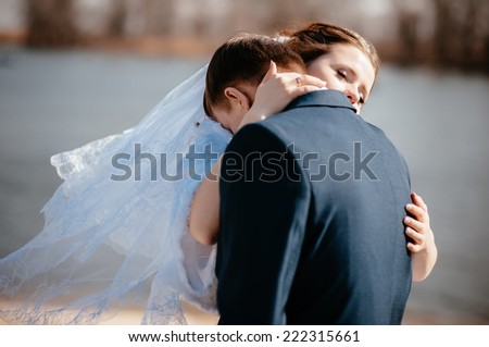 Beautiful wedding couple is enjoying wedding. Groom and Bride in a park. wedding dress. Bridal wedding bouquet of flowers. Wedding shot of bride and groom in park