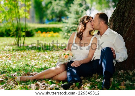 Groom and Bride in a park. wedding dress. Bridal wedding bouquet of flowers. Bride and Groom at wedding Day walking Outdoors on spring nature.  Loving wedding couple outdoor