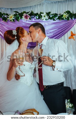 Newlyweds embraces. Beautiful newly married couple kissing at registry office.