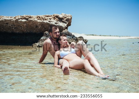 Couple on the beach of sea, love story. young couple having dream vacation on a beach