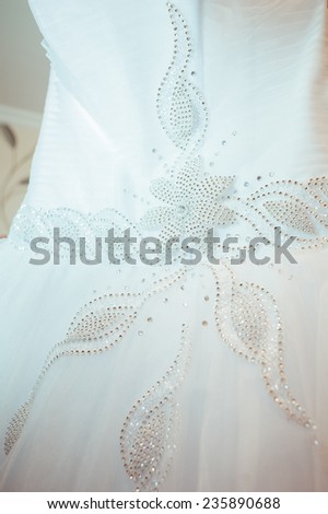 Beautiful white wedding dress ready for bride. wedding accessories. Wedding dress close-up.
