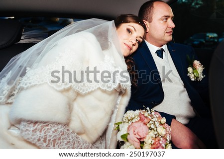 Bride and groom inside a classic car. They are happy. portrait of the happy bride and groom in the car.