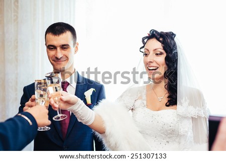 Bride And Groom With Cake Drinking Champagne At Reception. Wedding couple. The bride and groom.