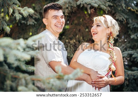 Happy bride and groom on their wedding. Groom and Bride in a park. wedding dress. Bridal wedding bouquet of flowers