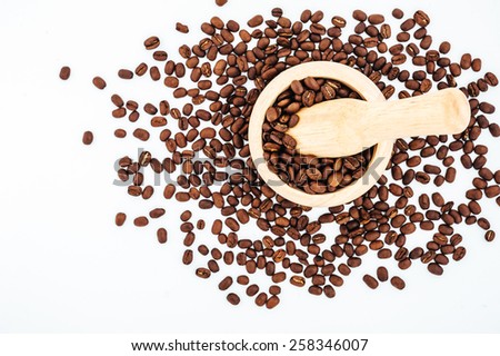 Coffee beans in wooden bamboo mortar isolated on white background. coffee beans isolated on white background.