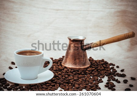 coffee on the table. Cup full of coffee beans on the cloth sack