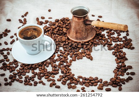 Coffee turk and Cup of Coffe. Coffee beans in shape of heart. coffee beans isolated on white background. roasted coffee beans, can be used as a background.