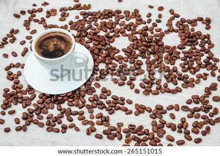 Coffee turk and Cup of Coffe and smile . Coffee beans in shape of heart. coffee beans isolated on white background. roasted coffee beans, can be used as a background.
