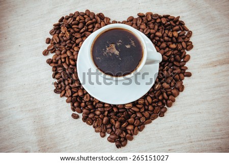 Cup of Coffee. Coffee beans in shape of heart. coffee beans isolated on white background. roasted coffee beans, can be used as a background.