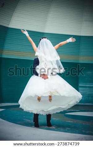 Bride and groom dancing in the park. Wedding dance in the open air. Dancers love flying.