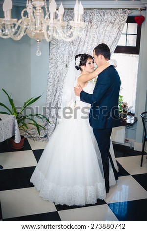 Wedding dance of charming bride and groom on their wedding celebration in a luxurious restaurant.