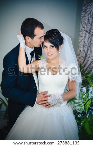 Charming bride and groom on their wedding celebration in a luxurious restaurant. Wedding bouquet of flowers and bridal dress. newly married couple in luxury modern hotel hall