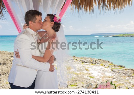 Couple getting marriage on the beach. Wild caribbean beach. Dominican republic. tropical sand beach in dominican republic. tranquil resort. Palm trees on the tropical beach, Caribbean Sea. beach in