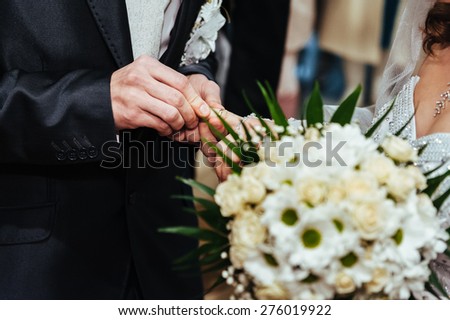 Wedding ceremony. Registry office. A newly-married couple signs the marriage document. Young couple signing wedding documents.