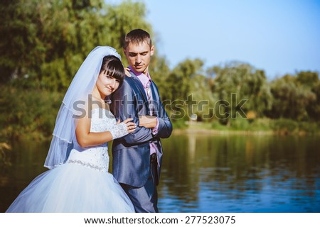 Married couple kissing on river beach. Bride Groom  couple wedding walking Outdoor on rivershore.