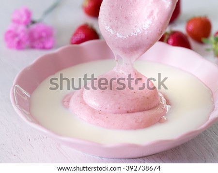 Delicious berry mousse with milk, strawberry and carnations