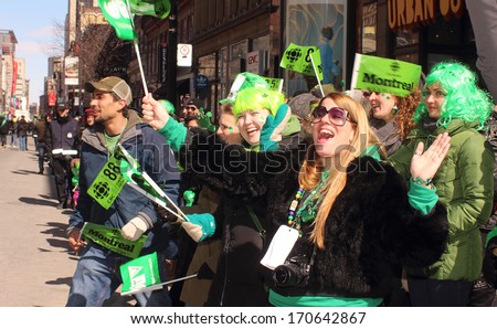 Montreal, Quebec, Canada - St. Patrick \'s Day March 17, 2013 in Montreal, Quebec.  Spectators cheer on marchers along St. Catherine Street during  annual St. Patrick\'s Day parade.