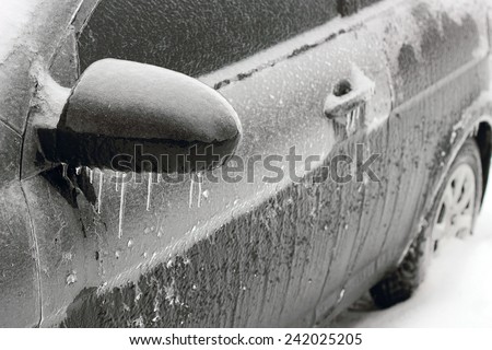 Ice covered black car, the aftermath of a winter storm