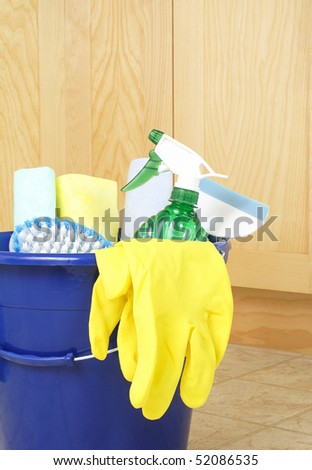 Cleaning supplies on kitchen floor in bucket
