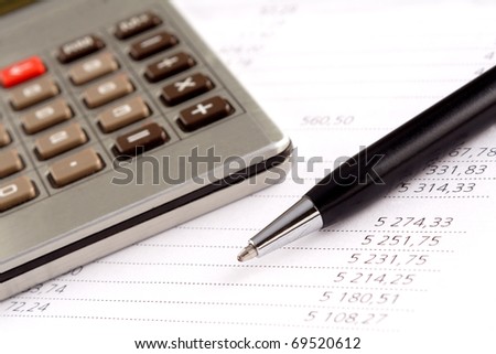 Financial statement, pen and calculator
