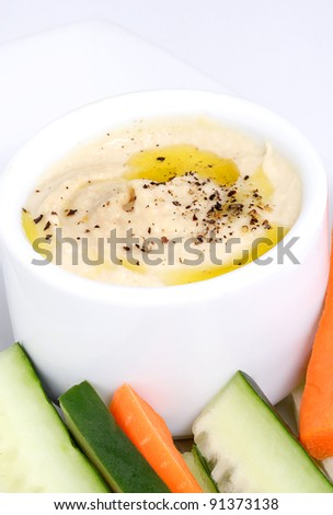 Cucumbers carrots and hummus are a healthy snack or appetizer