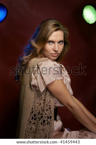 The beautiful girl in a photographic studio