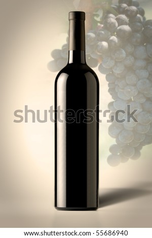 Red bottle of Wine with grapes in the background