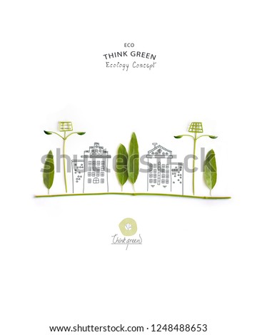 Environmentally friendly planet. Trees and solar street lights, made of green leaves with hand drawn sketches of a city houses. Minimal nature concept.Think Green. Ecology Concept.Flat lay.Top view.