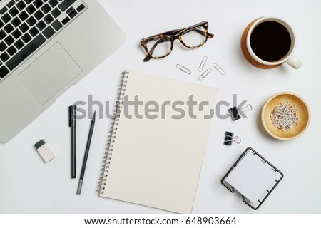 Top view workspace mockup on white background with notebook, pen, coffee, clips and accessories.