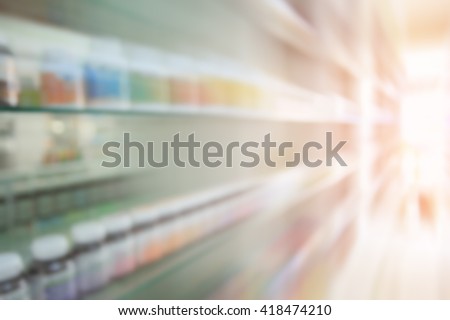 Pharmacy blurred and motion with store drugs shelves interior background.