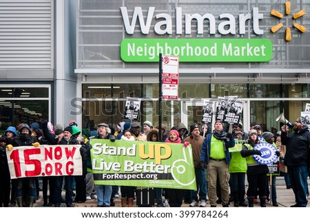 CHICAGO, ILLINOIS - NOVEMBER 28, 2014: Striking Walmart workers and supporters protest against low wages and charge that Walmart retaliates against employees who push for better working conditions.