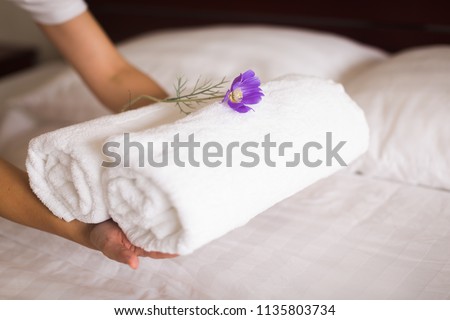 white hotel bed sheets and towel set. maid cleaning bed. Room service.