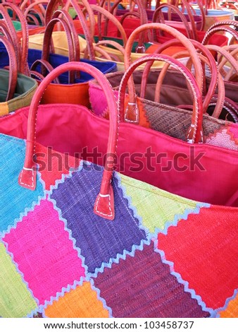 Colorful straw bags in a sunny day ready for sale at a street market, France