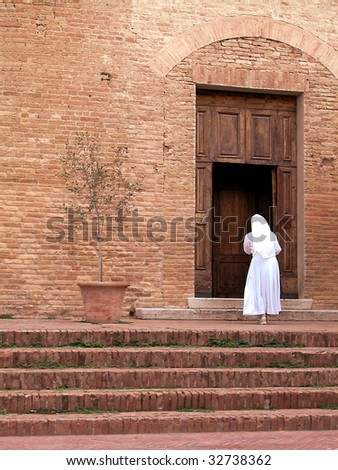 White dressed nun going to the church