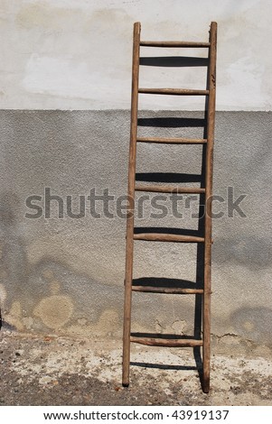 Old wooden stair against the wall of a old house