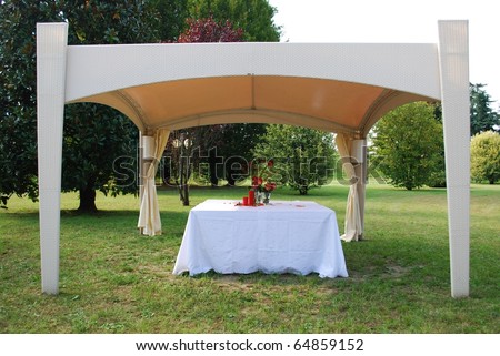 stock photo Wedding gazebo with red flowers and candles decoration in a 