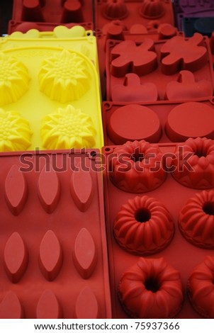 Colorful and differently shaped silicone baking pans on sale at market