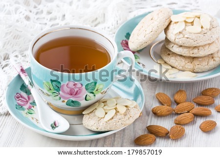 Cup of tea with almond cookies and almonds slices