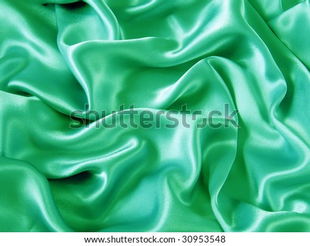 Smooth elegant green satin silk fabric as background