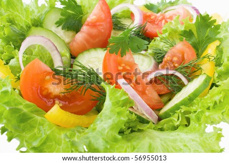 Salad from tomato, cucumber and lettuce leaves close-up