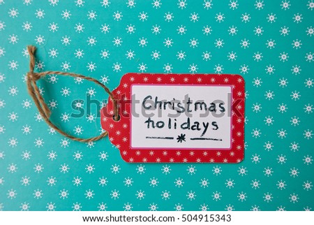 Label  handmade On Turquoise Paper with white Snowflakes,  Text Christmas holidays, New year event
