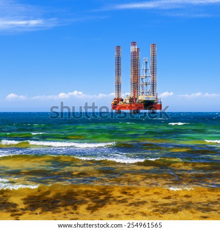 Offshore oil and Gas Production. Drilling platform in the sea against a blue sky